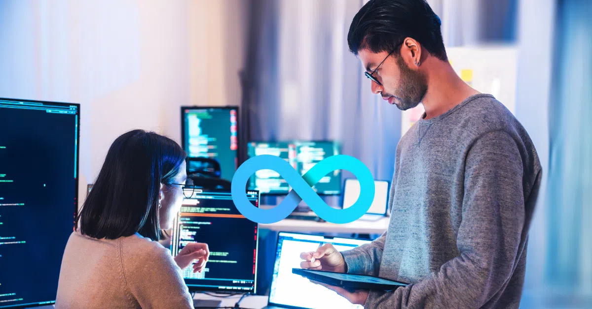 Two developers collaborating in front of multiple screens with code and the DevOps infinity symbol overlaid, representing continuous integration and delivery.